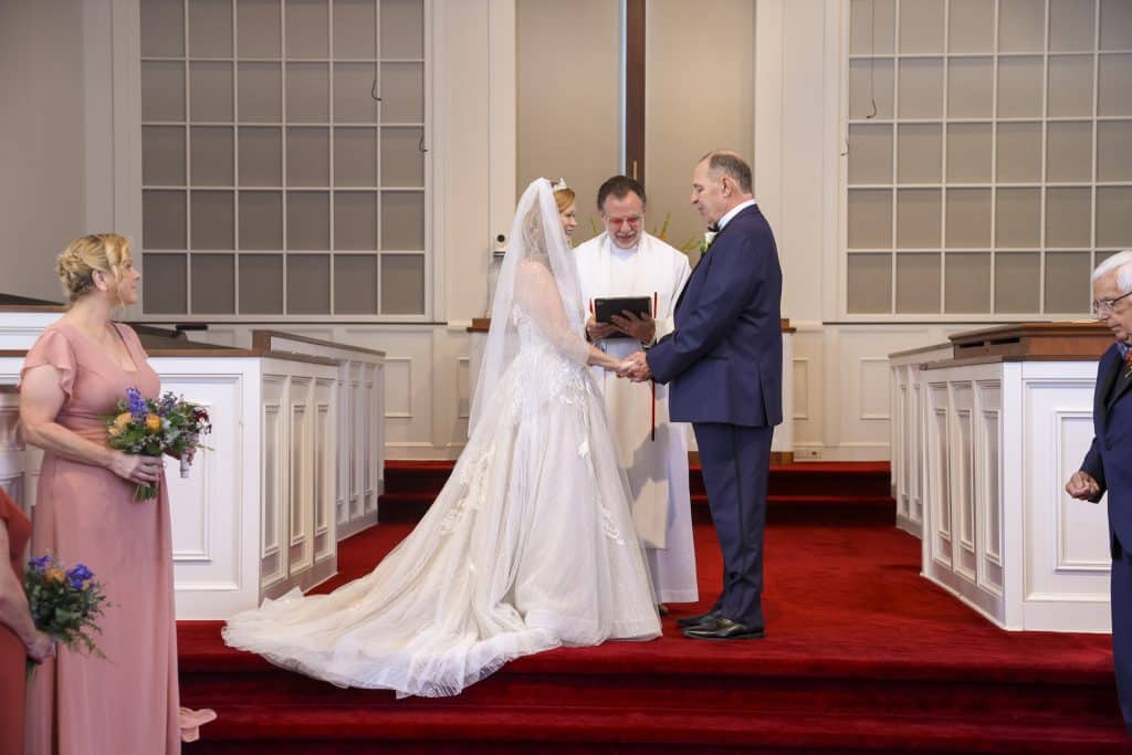 Tonya and David on the altar during the ceremony with their minister